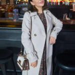 Haunted-Wedding-2024-Movie-Janel-Parrish-White-Coat